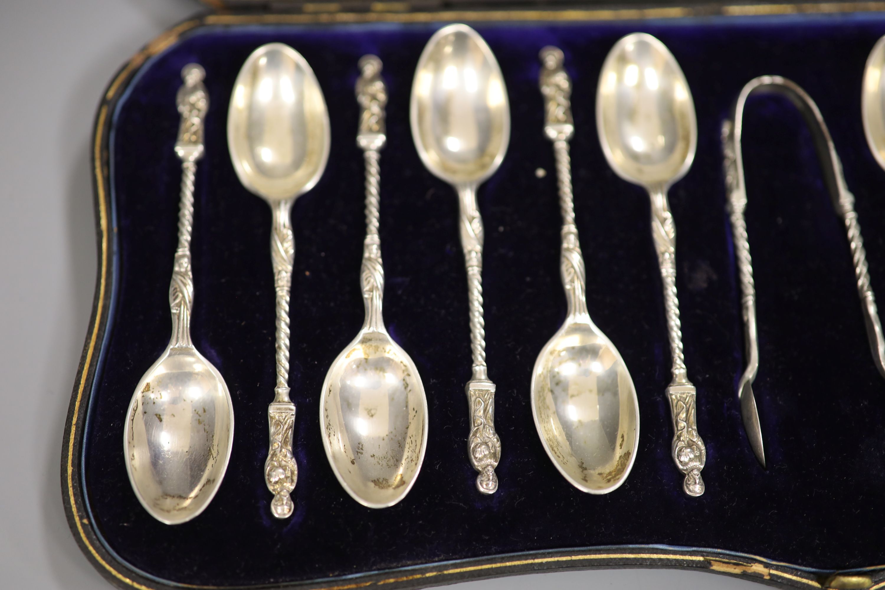 A late Victorian cased set of twelve silver apostle teaspoons and tongs, William Hutton & Sons, London, 1900.